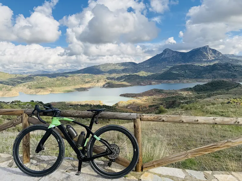 Gravel bike overlooking a lake in the mountains near Ronda